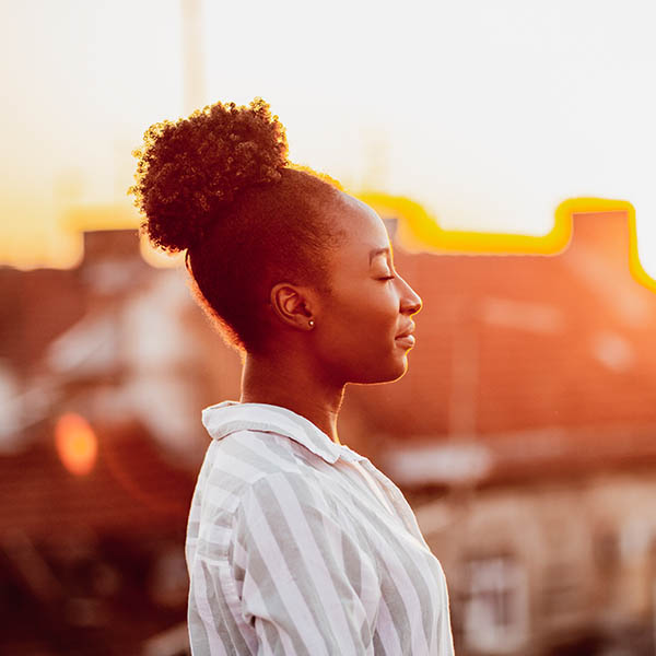 Young African American woman is relaxing on the rooftop